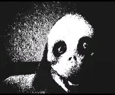 an alien man with big eyes in black and white