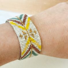 a close up of a person's arm wearing a bracelet with beads on it