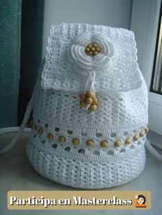 a white crocheted bag sitting on top of a counter next to a window