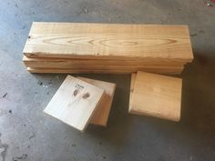 three pieces of wood sitting on the ground next to each other, with one piece missing