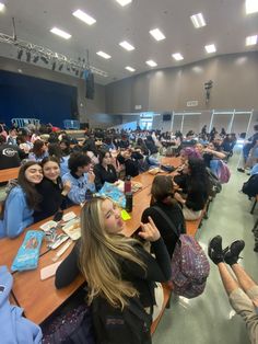 a large group of people sitting at long tables