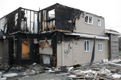 a fire damaged house with the roof ripped off