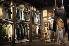 a room filled with lots of clothes on display