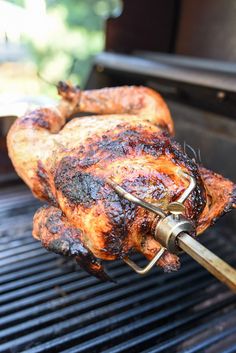 a chicken is being cooked on the grill