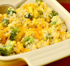 a casserole dish with broccoli and rice in it on a table