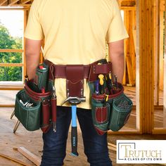 a man holding tools in his hands and wearing a tool belt with two pockets on the back