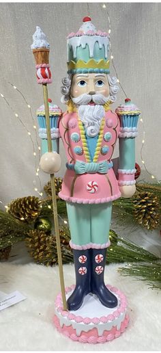 a christmas ornament with a nutcracker holding a cupcake