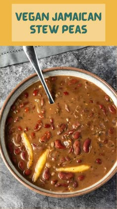 a bowl filled with stew and beans on top of a table