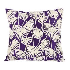 a purple and white pillow with large leaves on the front, sitting on a white background