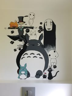 an image of a wall with totoro and other cartoon characters on the wall