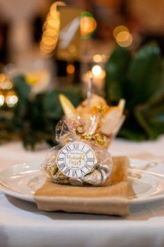 a small clock sitting on top of a white plate