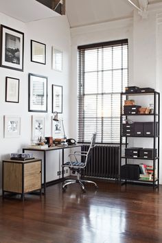 a room with a desk, shelves and pictures on the wall above it is also a chair