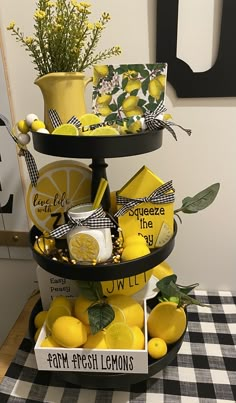 a three tiered tray with lemons and other items