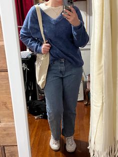 A person stands in front of a mirror wearing a blue sweater over a white shirt. The person also has a white tote bag and is wearing white shoes. Baggy V Neck Sweater Outfit, V Neck Sweater With Shirt Underneath, Sweater With Collared Shirt Outfit, Blue Longsleeves Outfit, Blue V Neck Sweater Outfit, V Neck Sweater Outfits, Sweaters With Collared Shirts, Vneck Sweater Outfit, V Neck Sweater Outfit