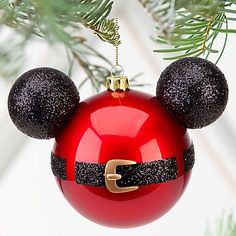 a mickey mouse ornament hanging from a christmas tree with the letter c on it