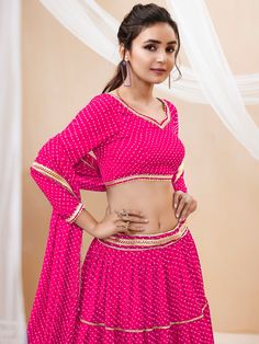 Introducing a charming pink georgette lehenga that is perfect for enhancing your festive wardrobe. This exquisite ensemble features a lehenga adorned with leheriya printed work and beautiful lace detailing, creating a visually stunning and elegant look. The semi-stitched lehenga allows for a customizable fit up to 42 inches, ensuring both comfort and style for every occasion. The soft, pastel pink color, paired with intricate patterns, makes this outfit a perfect choice for events, functions, fe Bollywood Style Pink Palazzo Set With Pallu, Pink Palazzo Set With Dori Work For Navratri, Pink Gota Work Sets For Navratri, Pink Sets With Gota Work For Navratri, Traditional Pink Georgette Sets, Unstitched Pink Bollywood Choli, Pink Unstitched Bollywood Choli, Pink Sharara With Pallu For Navratri, Bollywood Style Pink Sets With Gota Work