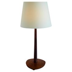 a wooden table lamp with a white shade on it's base and a wood base