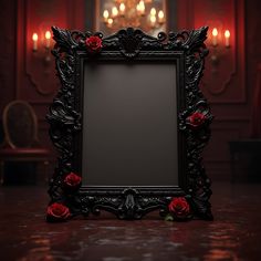 an ornate black frame with red roses in front of a chandelier filled with candles