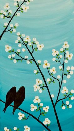 two birds sitting on a branch with white flowers in front of blue sky and water