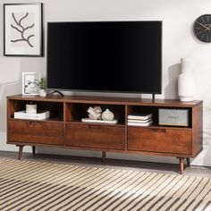 a flat screen tv sitting on top of a wooden entertainment center