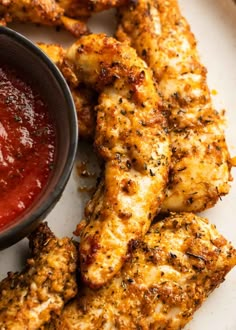 chicken wings with ketchup and sauce on a white plate, ready to be eaten