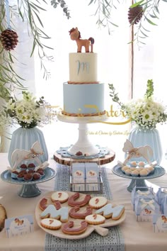 a table topped with cookies and cakes covered in frosting