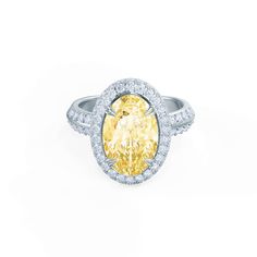 an oval shaped diamond ring with halos