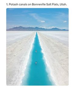 an aerial view of a long stretch of blue water in the middle of a desert