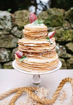 a stack of pancakes with strawberries on top