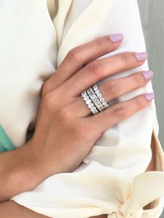 a woman's hand with three rings on it