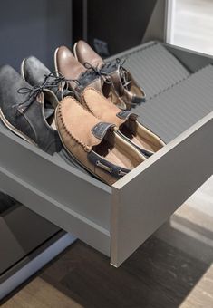 two pairs of shoes are sitting in a drawer