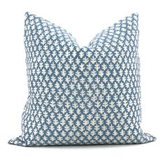 a blue and white pillow on a white background