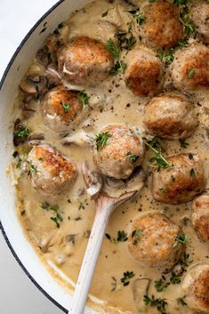 a pan filled with meatballs covered in gravy