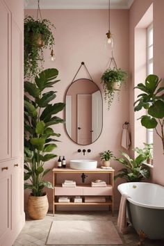 a pink bathroom with potted plants and a mirror on the wall, along with a claw foot bathtub