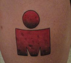 a close up of a person's leg with a tattoo on it that says m