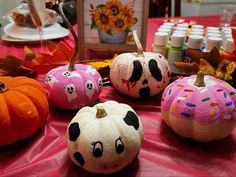 some painted pumpkins sitting on top of a table