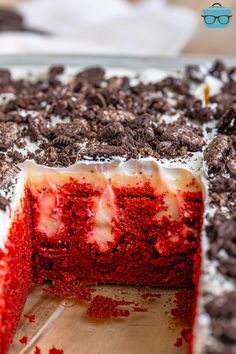 a red velvet cake with white frosting and chocolate chips