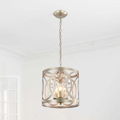 a chandelier hanging from the ceiling in a room with white walls and flooring