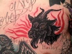 a man with tattoos on his chest has a goat and demon tattoo