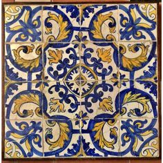 an old tile with blue and yellow designs on it