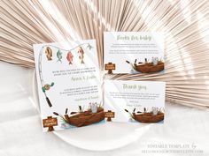 two wedding cards on a plate with the same boat as it sits next to each other