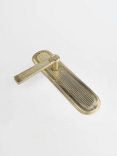 an antique brass door handle on a white background