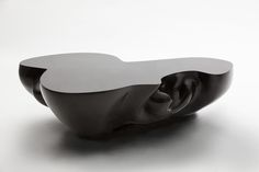 an abstract black and white sculpture sitting on top of a table