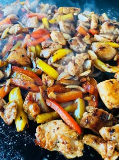 chicken and peppers are being cooked on the grill