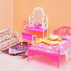 a doll house bedroom with furniture and accessories on the floor, including a pink bed