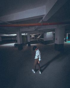 a person walking in an empty parking garage