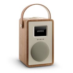 the radio is made out of wood and has an alarm clock on it's side