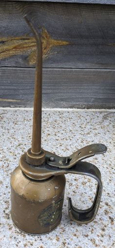 a pair of scissors are sitting on top of an old fashioned teapot with no handle