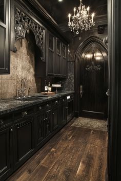 an ornate kitchen with black cabinets and wood floors