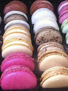 there are many different colored macaroons in the tray